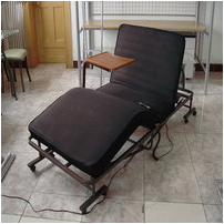 Folding bed with bedside table
